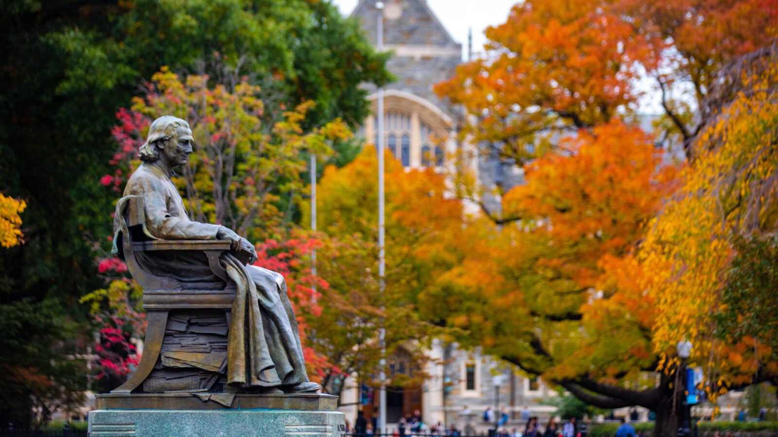 john carroll statue with fall leaves