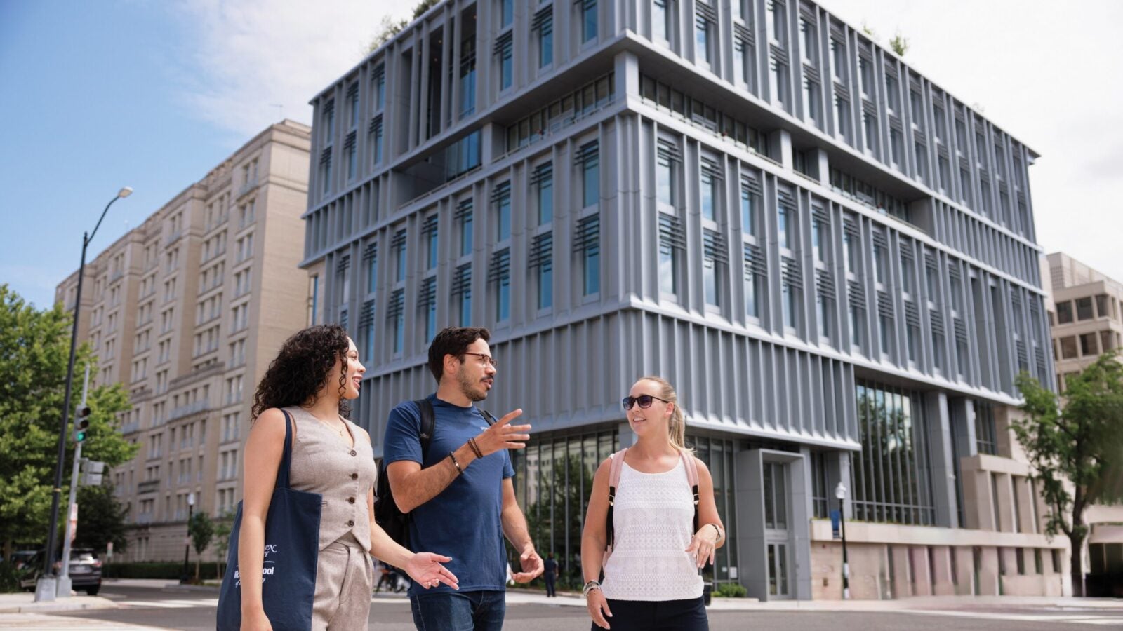 students walking around 124 e campus building