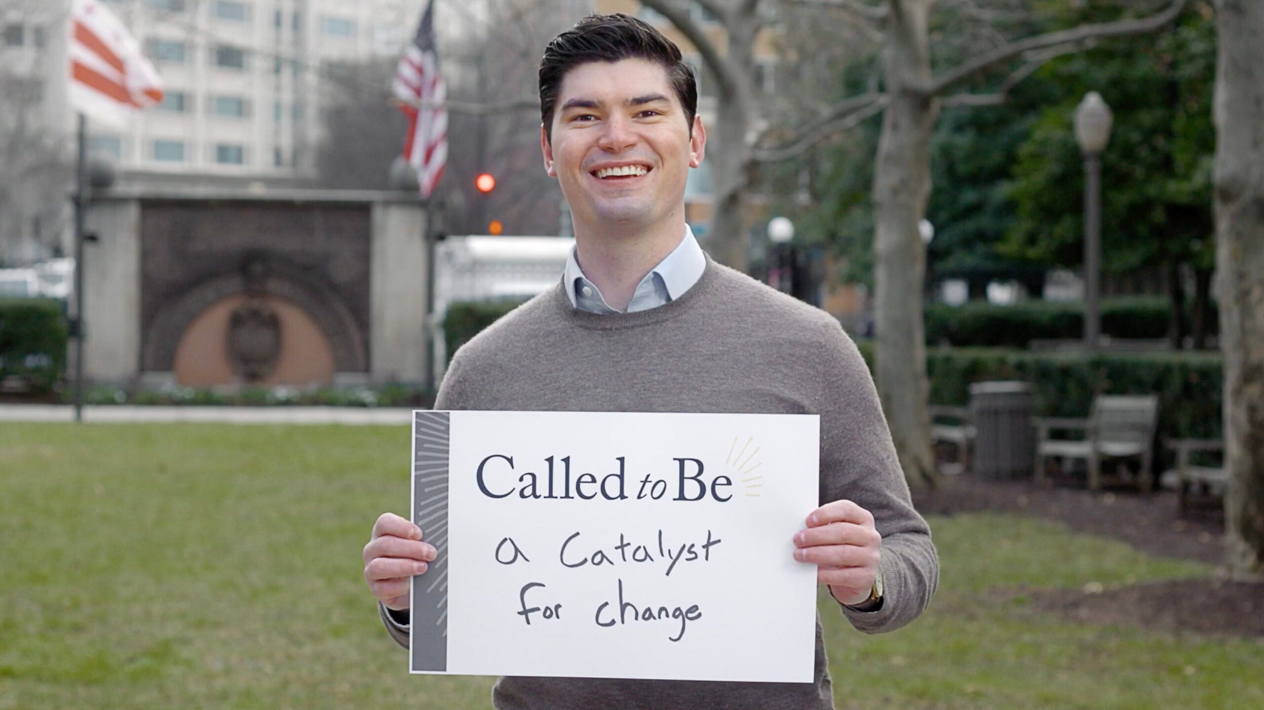 Trey Wolf (L'24) holding sign stating 
