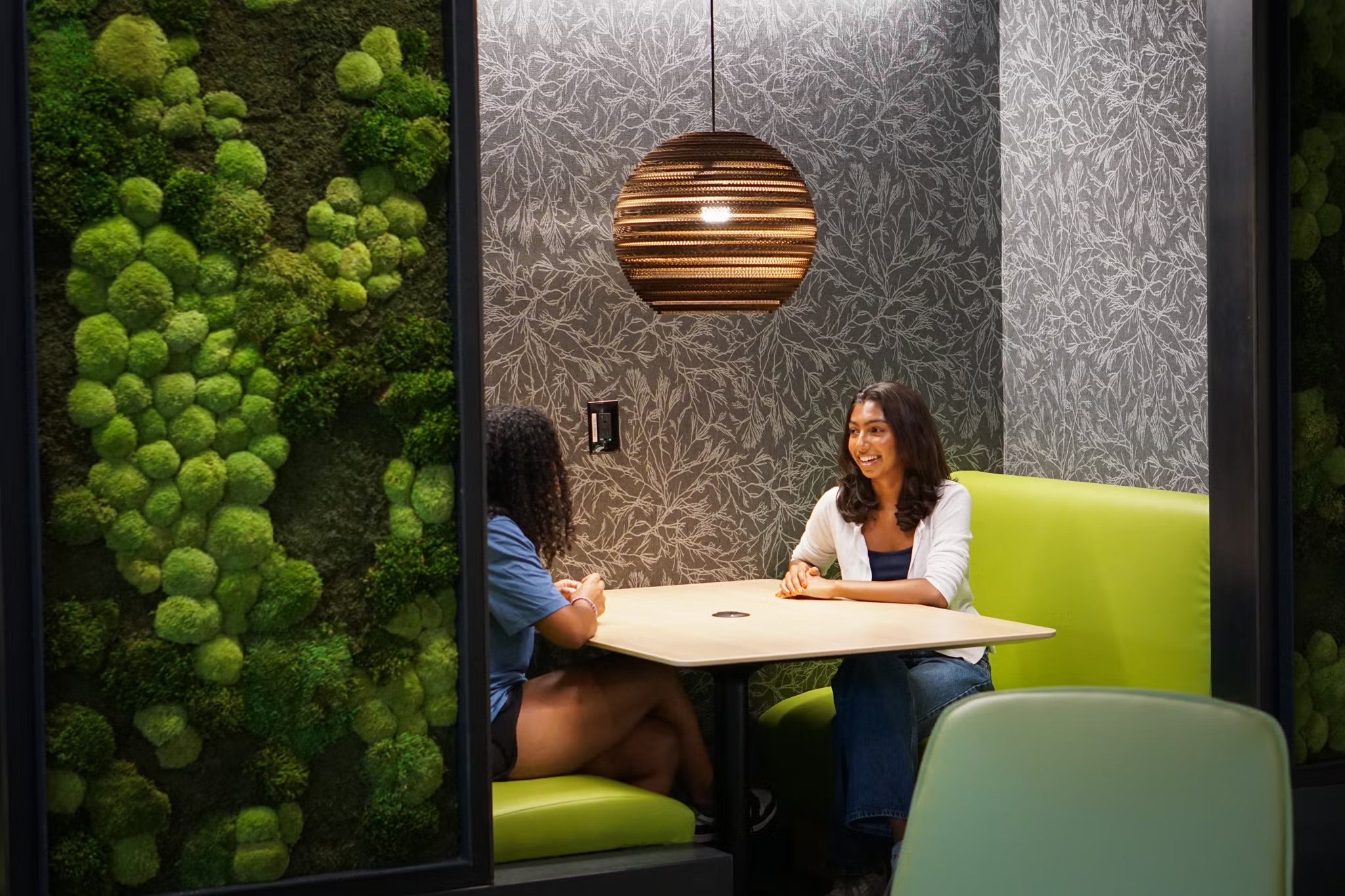 students sitting in communal space