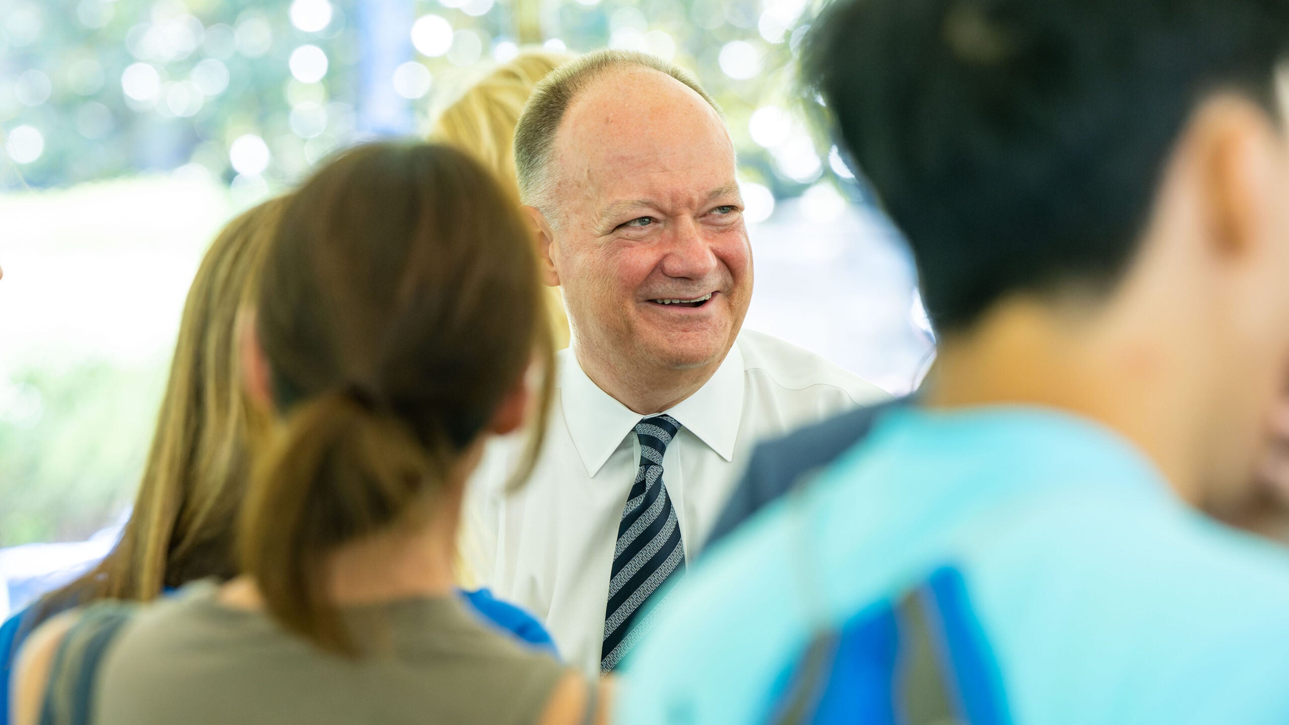 jack degioia smiling with students