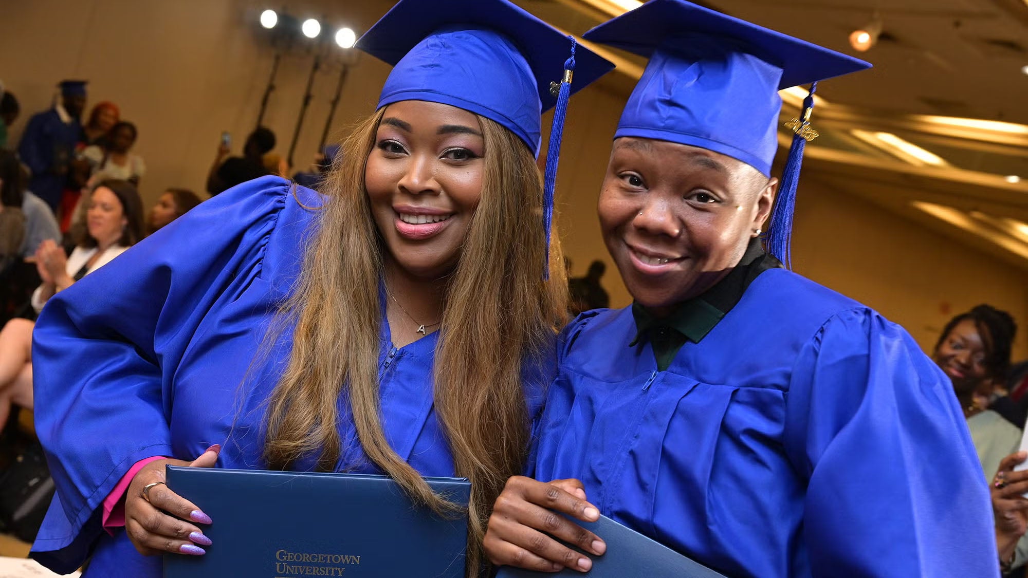students smiling at graduation