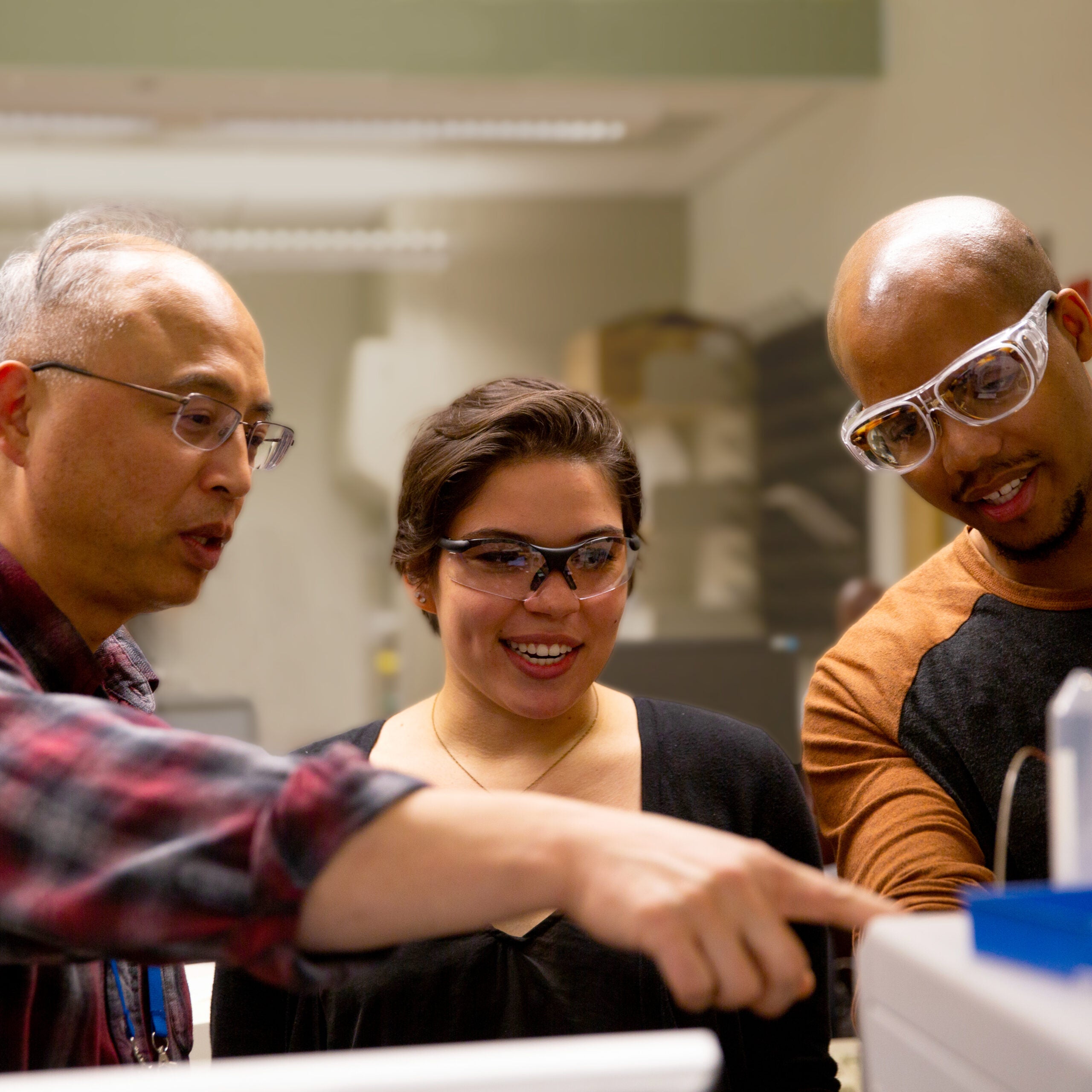 professor working with students at a lab