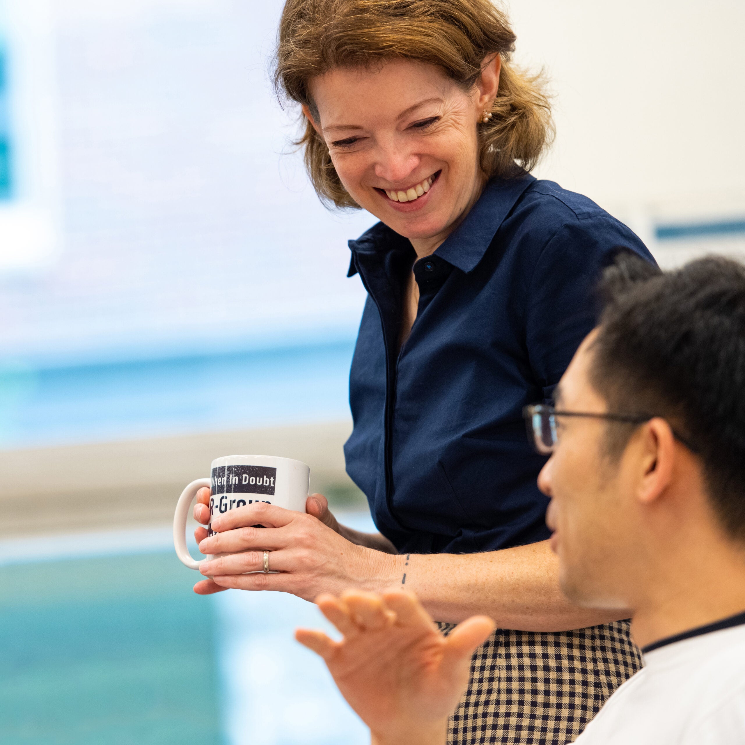 heidi elmendorf smiling at student during class