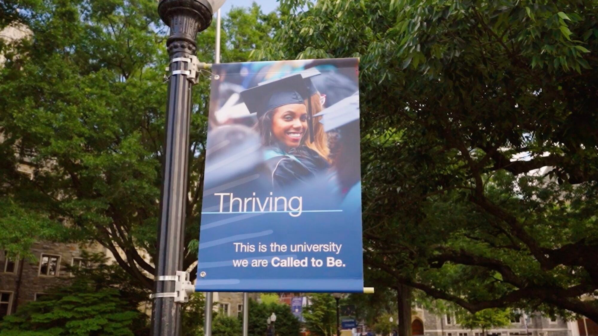 Campaign close video thumbnail with the image of a women at graduation exemplifying thriving